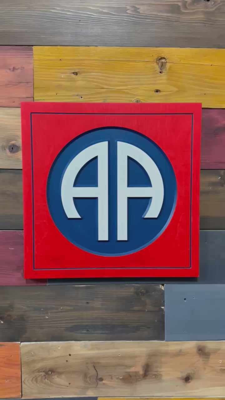 Close up detail of 82nd Airborne Division AA insignia carved wood wall sign
