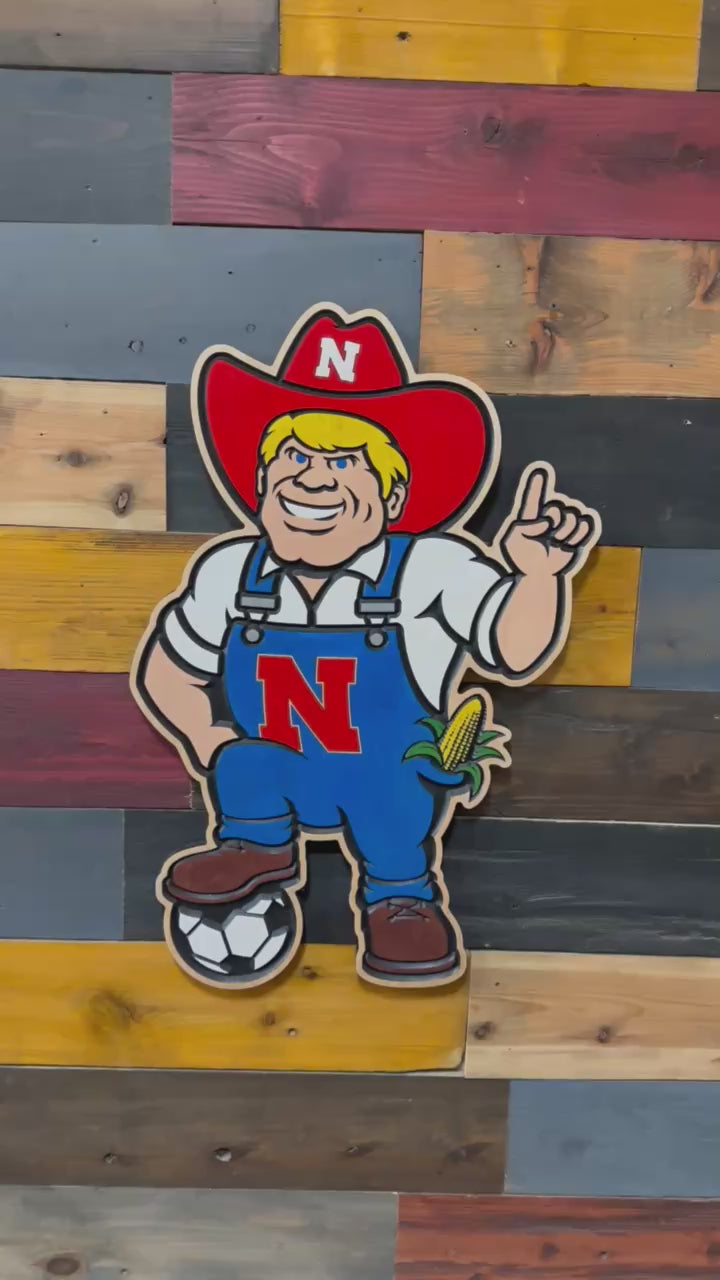 Handcrafted Herbie Husker soccer wood sign featuring Nebraska Cornhuskers mascot