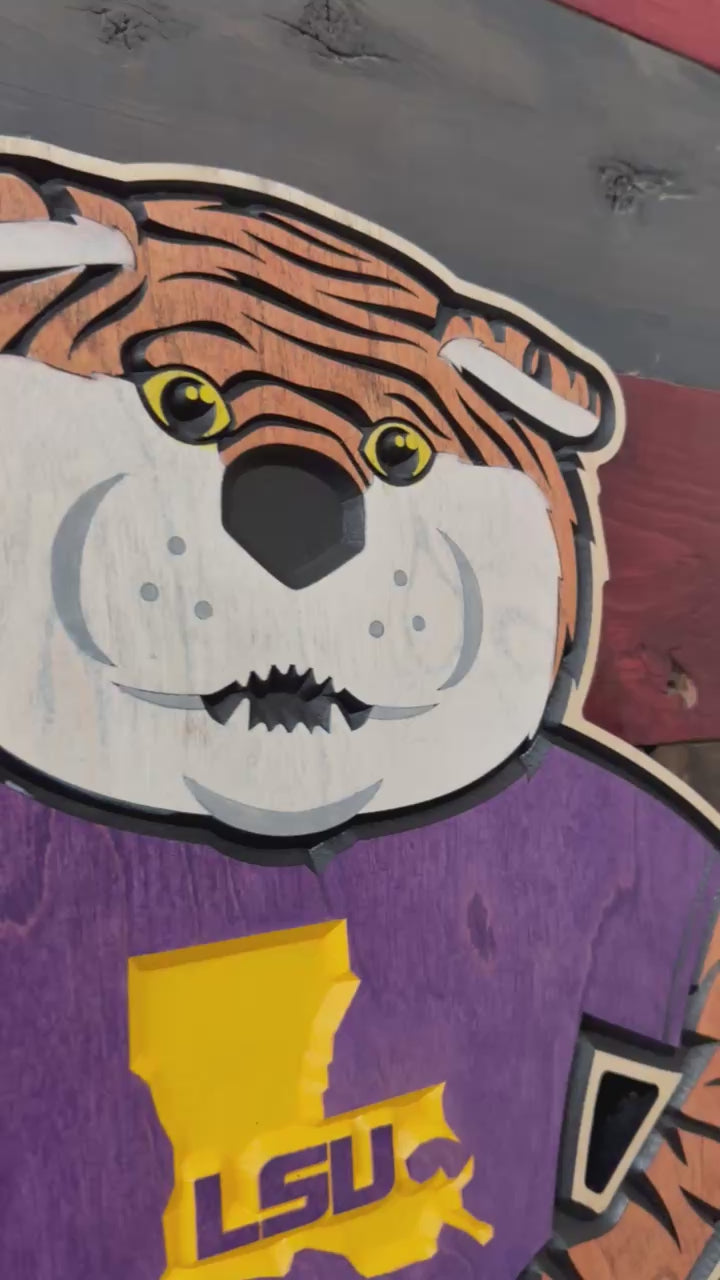 Take a closer look at our officially licensed LSU Mike the Tiger Mascot Wood Sign. Precision CNC carved, hand-painted, and handcrafted in Nebraska, this unique wall art features Mike the Tiger wearing an LSU shirt and is perfect for LSU fans, alumni, and collectors.