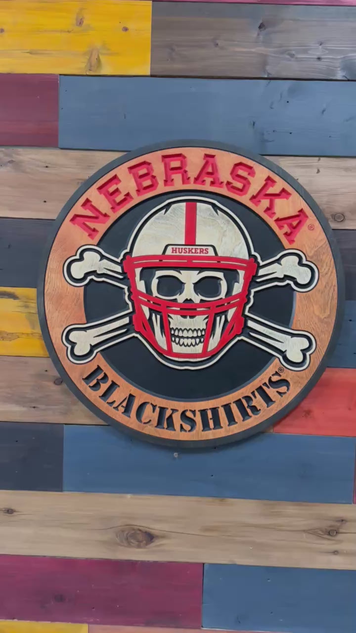 Close-up of carved Blackshirts skull and crossbones wood sign detail