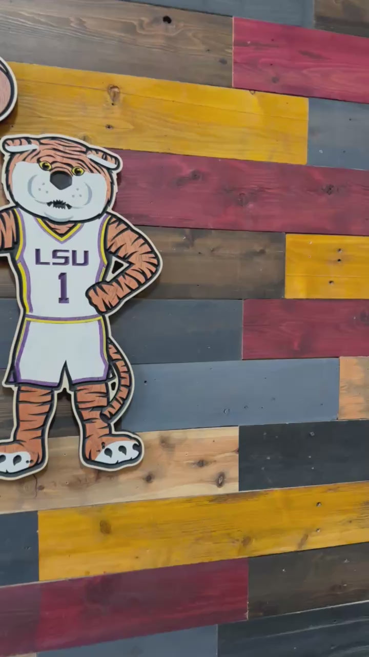 Take a closer look at our officially licensed LSU Mike the Tiger Basketball Wood Sign. Precision CNC carved, hand-painted, and handcrafted in Nebraska, this unique wall art features Mike the Tiger spinning a basketball and is perfect for LSU basketball fans, alumni, and collectors.