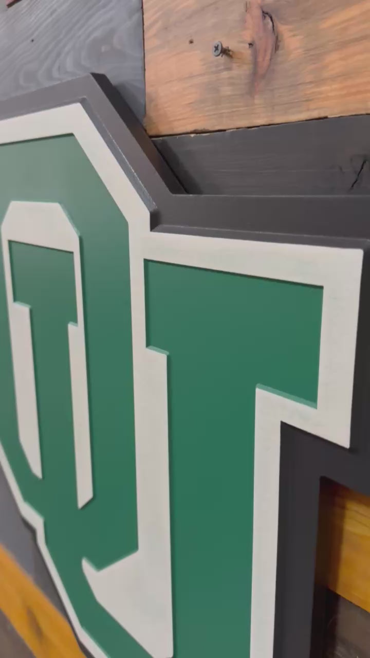 Video highlighting dimensional carving, layered painted detail, and handcrafted Ohio University OU logo craftsmanship