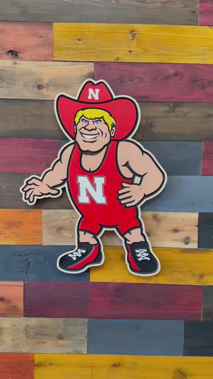 Handcrafted Herbie Husker wrestling wood sign featuring Nebraska Cornhuskers wrestling mascot