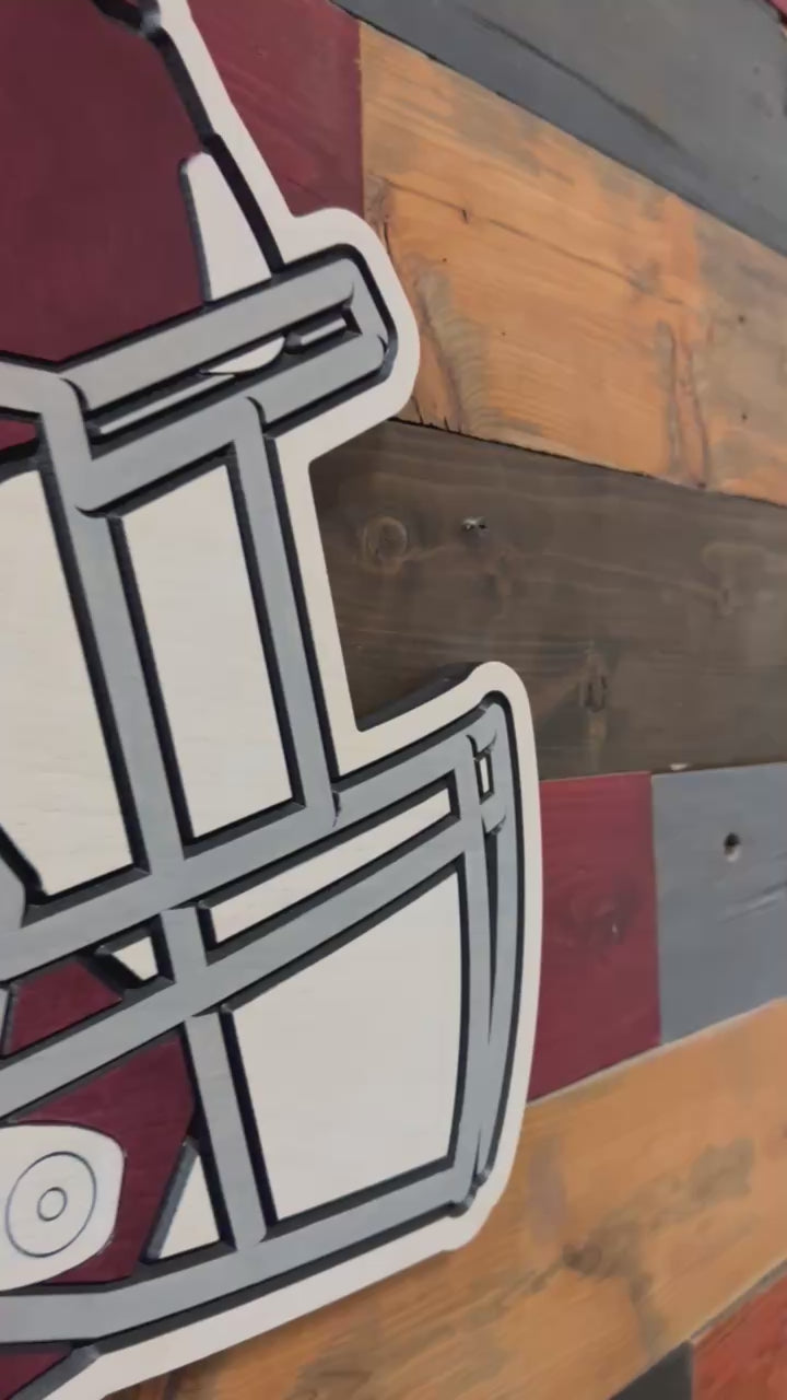 Take a closer look at our officially licensed Texas A&M Aggies Helmet Wood Sign. Precision CNC carved, hand-painted, and handcrafted in Nebraska, this premium wall art showcases the iconic ATM logo on a football helmet and is perfect for Aggie fans, alumni, offices, and fan caves.