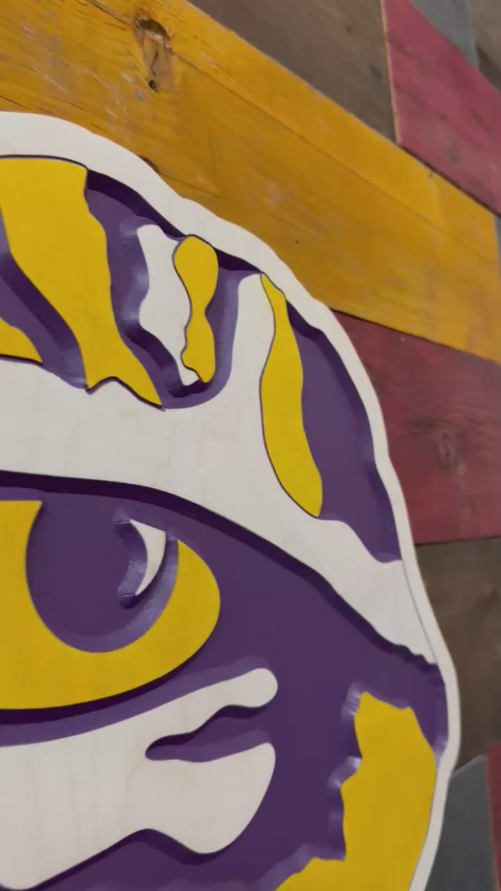 Video showcasing layered carving depth and handcrafted LSU Tiger Eye design with dimensional purple and gold detail