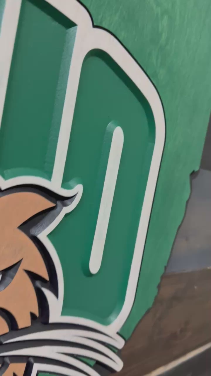 Video highlighting dimensional carving, layered mascot detail, and Ohio state silhouette craftsmanship on an Ohio University wood wall sign
