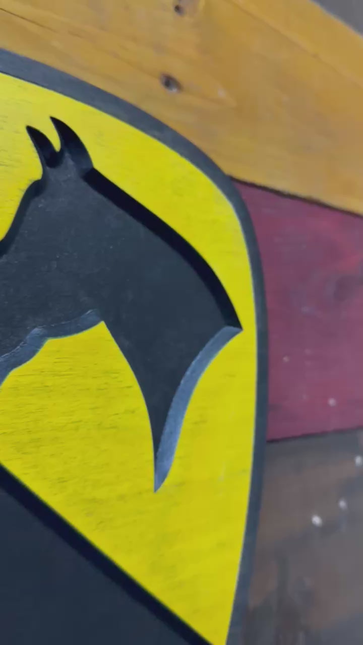 Close up video of 1st Cavalry Division black border carved wood wall sign showing detail and finish