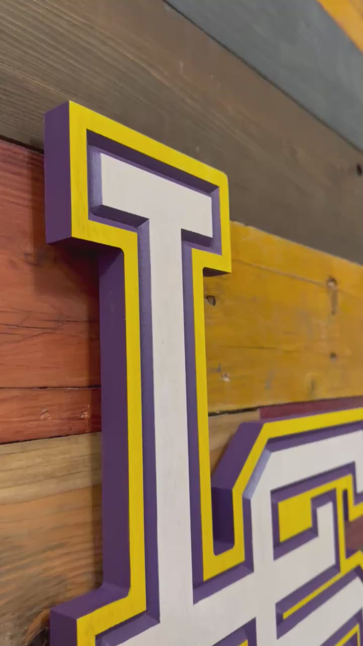 Video showcasing handcrafted vertical LSU logo wall art with layered carving depth and dimensional purple and gold detail