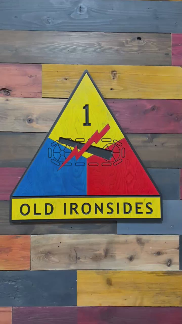 Close up video of handcrafted 1st Armored Division Old Ironsides wood wall sign showing carved detail and finish