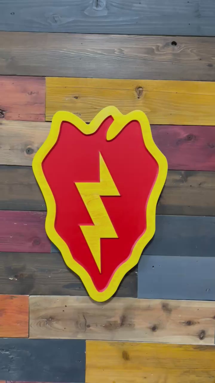 Close up detail of 25th Infantry Division Tropic Lightning carved wood sign showing lightning bolt and layered paint