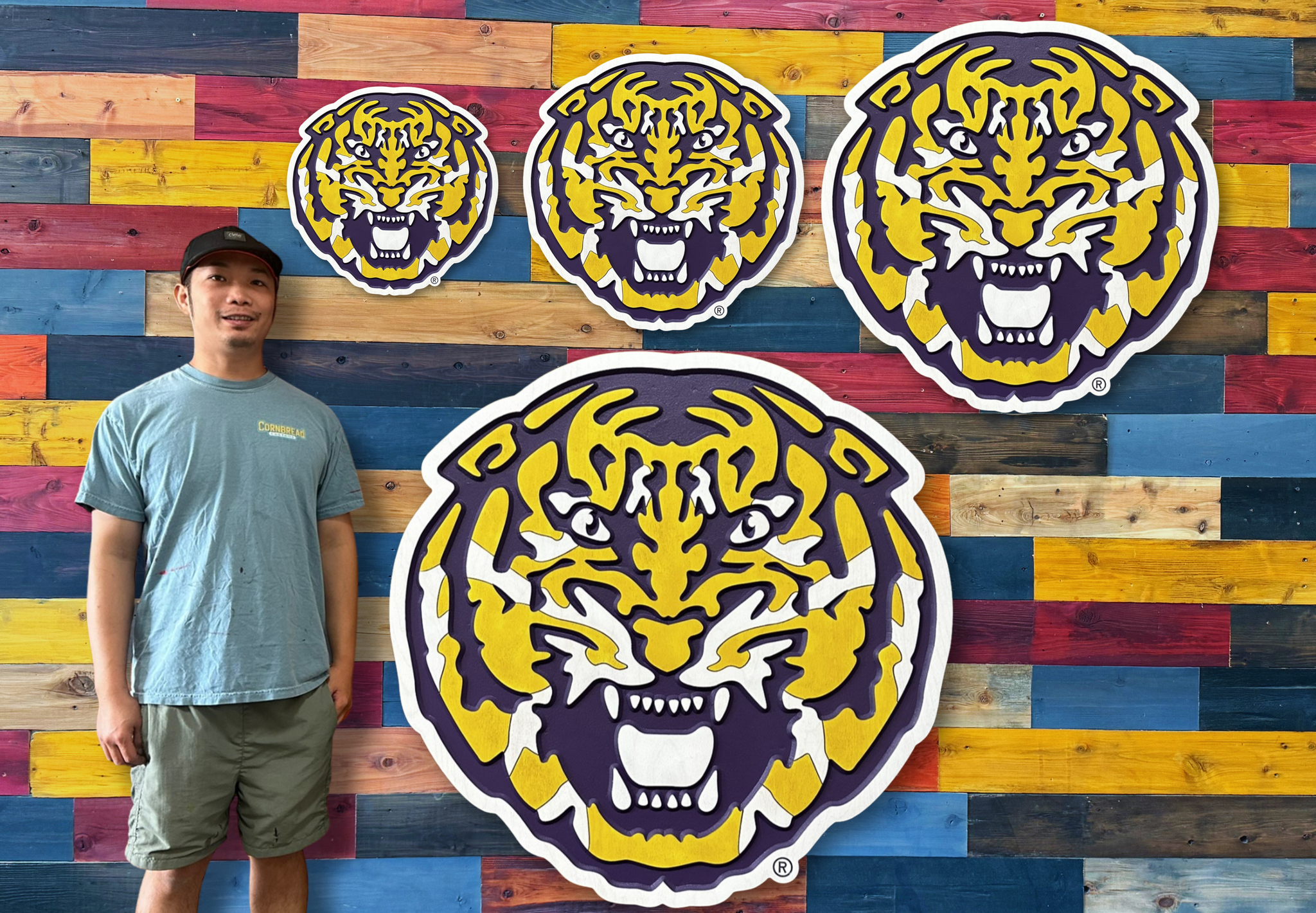 Person standing in front of a colorful wall with tiger logos