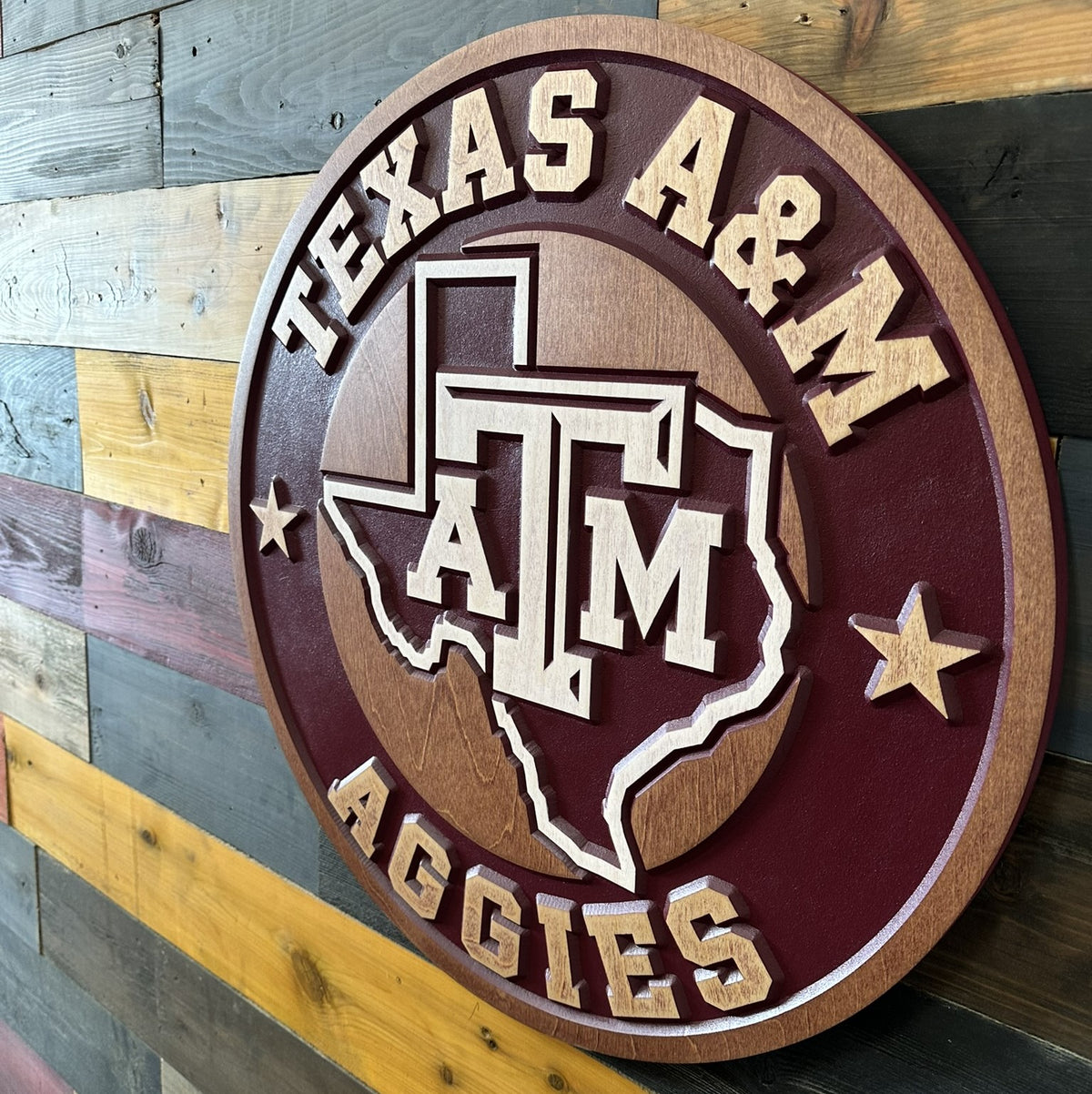 Close-up of carved Texas A&M ATM logo and Texas state silhouette