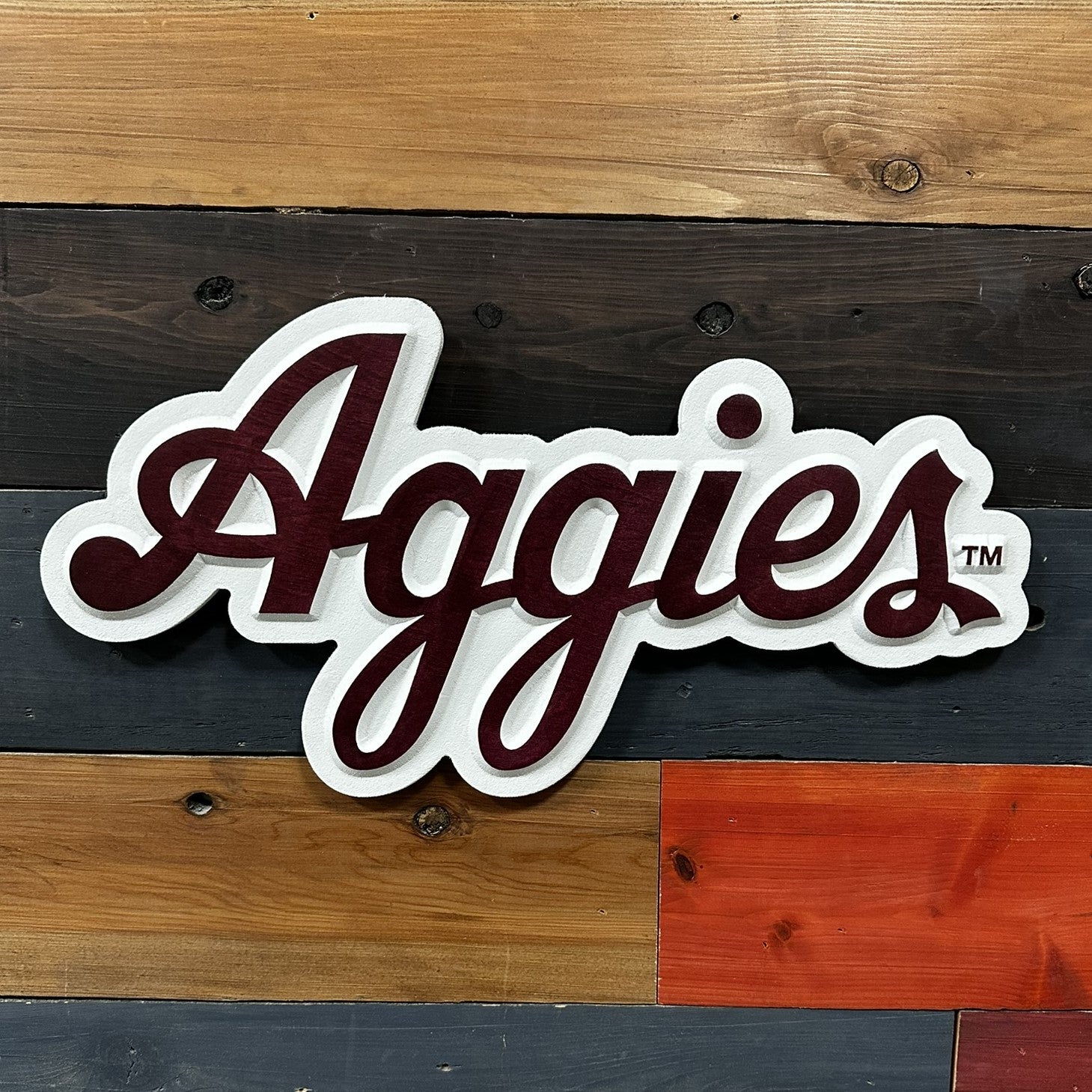 Angled view of a handcrafted Texas A&M Aggies Script Logo Wood Sign