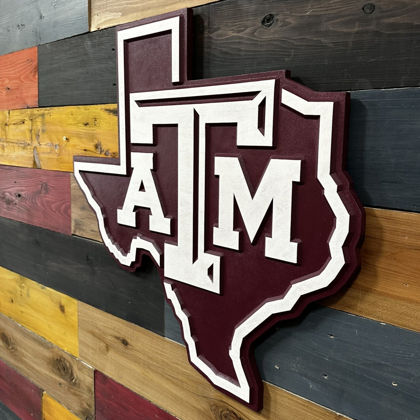 Texas A&M Aggies logo displayed over the Texas state outline in handcrafted wood wall art