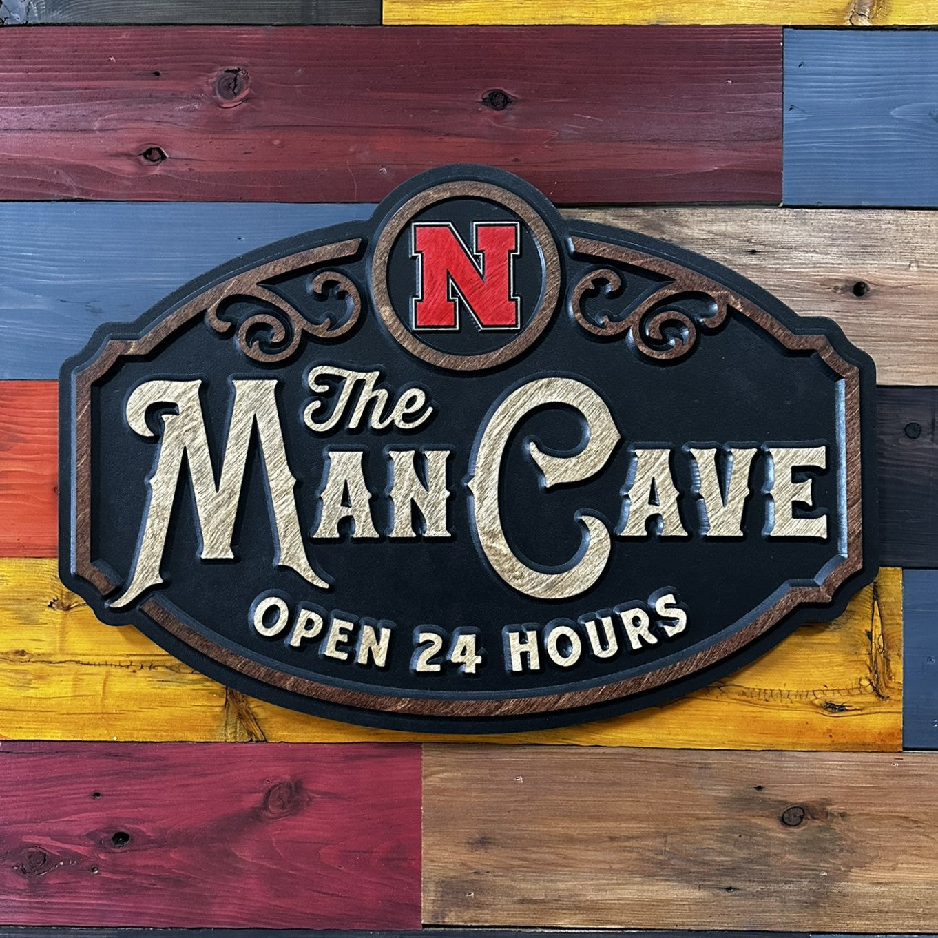 Close-up of carved Nebraska Man Cave wood sign detail