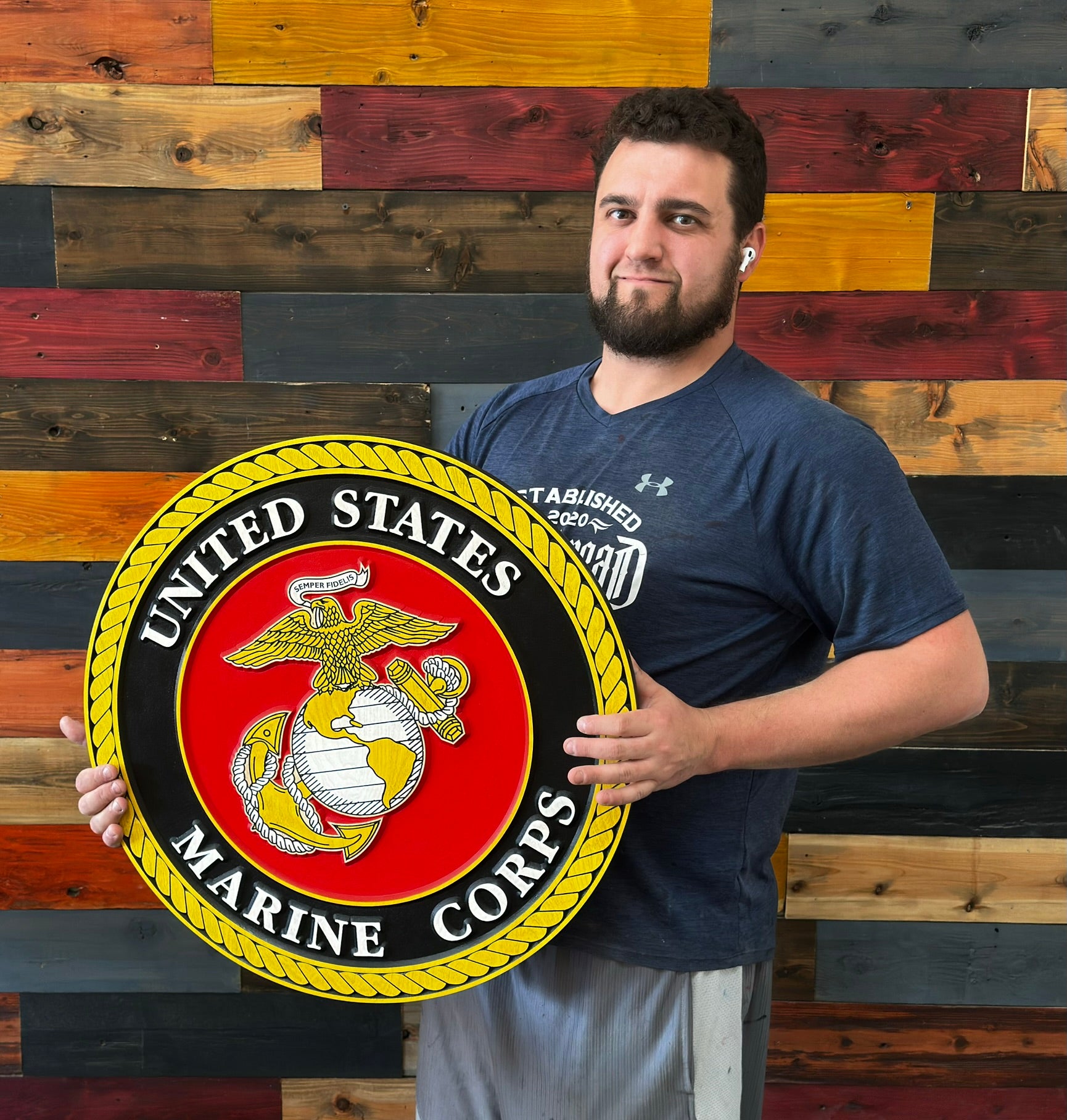 United States Marine Corps emblem wood sign being held for size reference