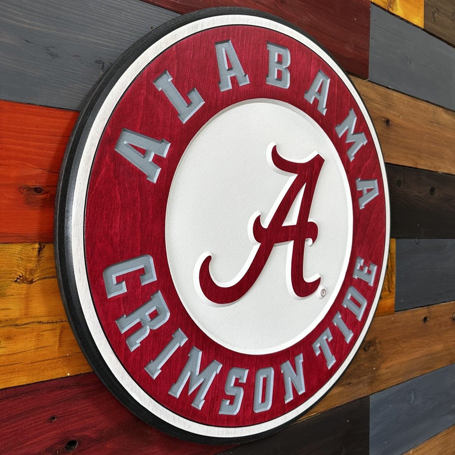 University of Alabama round wood sign displayed on wall
