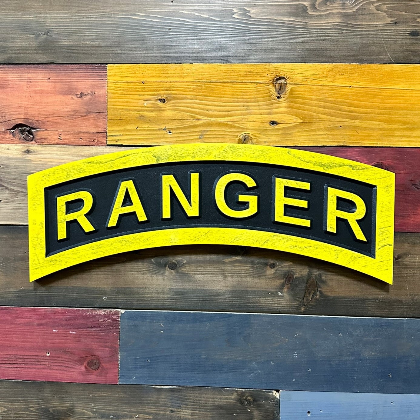 US Army Ranger tab yellow and black carved wood wall sign mounted on wall