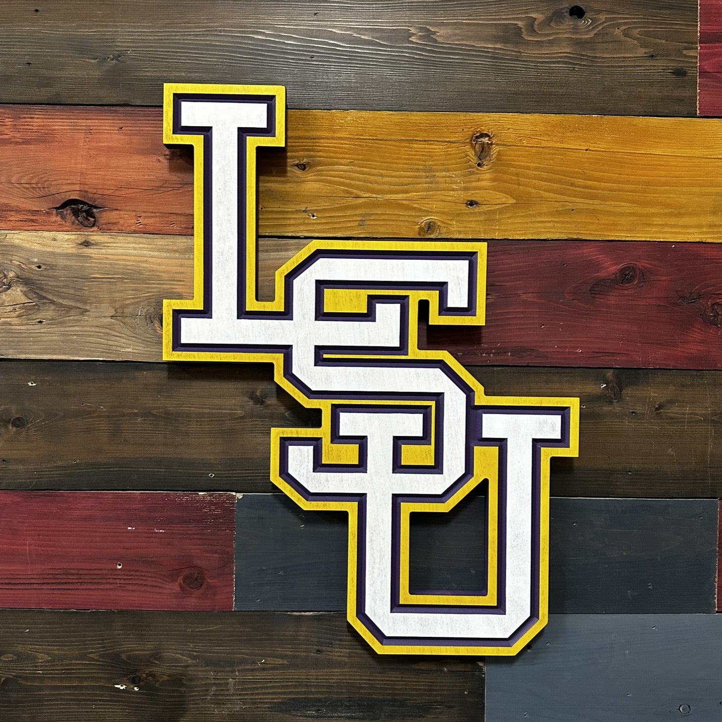 Angled front view of vertical LSU wooden wall decor showing dimensional collegiate lettering and handcrafted carved detail